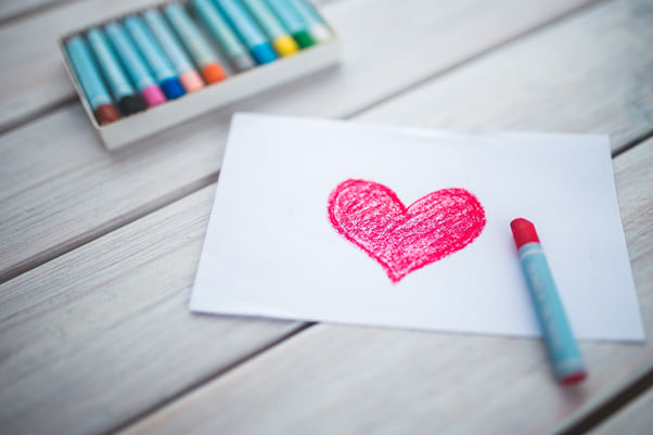 A heart drawn with a crayon on a piece of paper